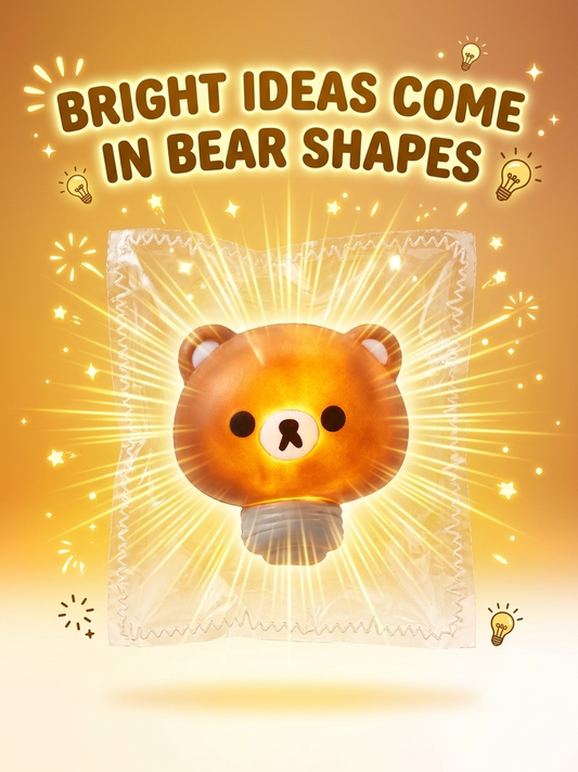 A stylized promotional graphic with the text 'BRIGHT IDEAS COME IN BEAR SHAPES' above a glowing bear-shaped light bulb wrapped in clear plastic, on a warm yellow-orange background with sparkles and lightbulb icons.