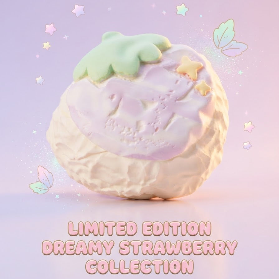 A pastel-colored strawberry-themed decorative object or toy with a cream base, pale pink top, and mint green leaf detail, shown on a soft lavender background with floating stars and leaves. Text at the bottom reads 'LIMITED EDITION DREAMY STRAWBERRY COLLECTION'.