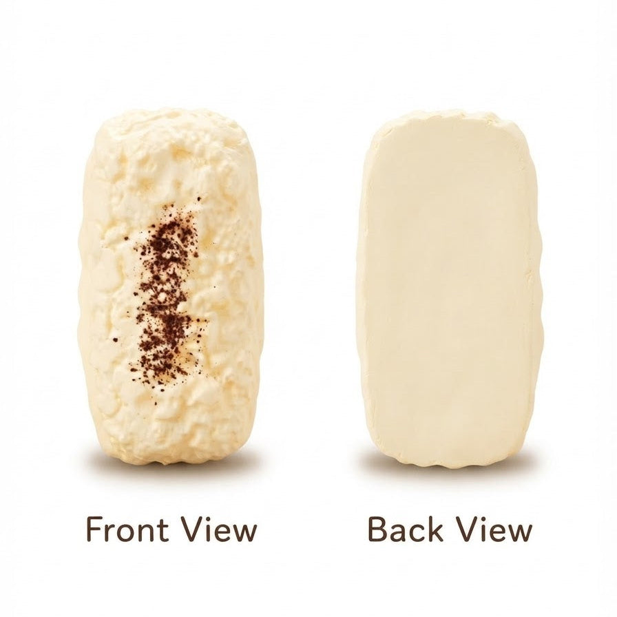 A cream-colored rectangular bar of soap shown from both front and back views on a white background. The front view shows a textured surface with a vertical streak of dark brown speckles, and the back view is smooth and solid.