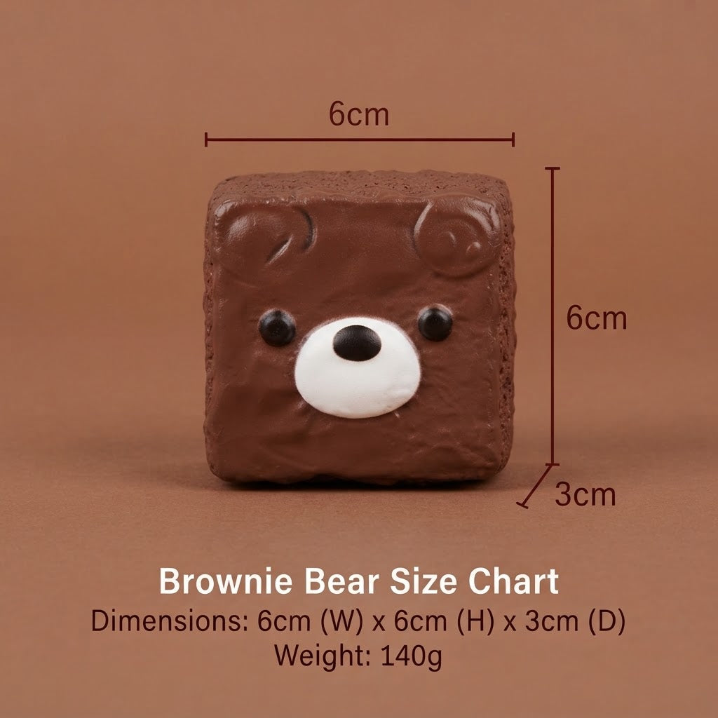 Brownie Bear size chart showing a square brown bear-shaped item with a white snout and black eyes, with dimension lines indicating 6cm width, 6cm height, 3cm depth, and text listing dimensions and 140g weight on a brown background.