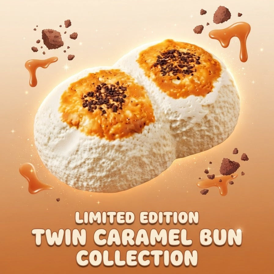 Two white fluffy buns topped with caramel and dark chocolate sprinkles, set against a warm beige and orange gradient background with caramel drips and the text 'LIMITED EDITION TWIN CARAMEL BUN COLLECTION'.