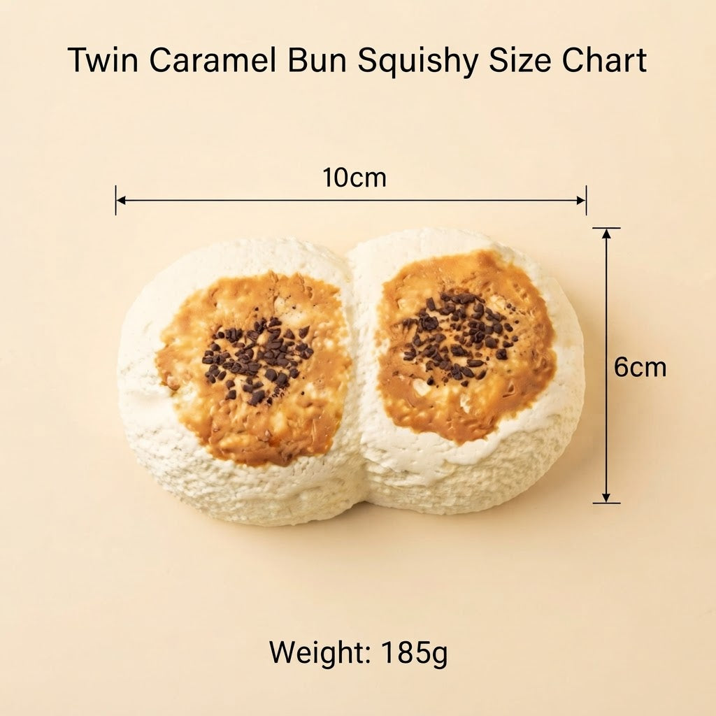 Twin Caramel Bun Squishy size chart on a beige background, showing the product dimensions as 10cm by 6cm, with a weight of 185g. The product consists of two soft, white, dough-like buns topped with caramel-colored caramel sauce and dark chocolate chips.