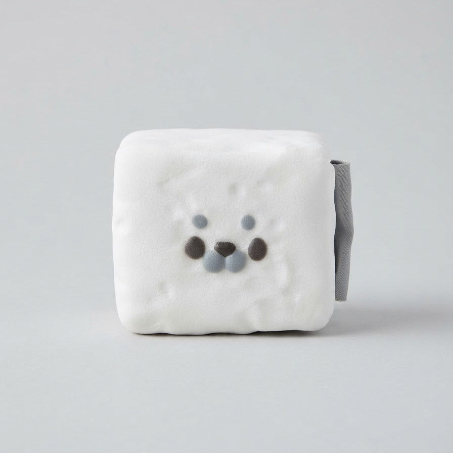 A white, cube-shaped plush or foam toy with a small bear face made of gray and dark brown dots, shown on a light gray background.