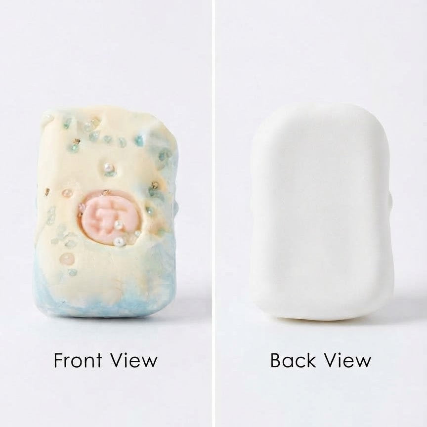 A split-screen product photo showing a small rectangular handmade soap or ceramic object from two angles on a white background. The left side is labeled 'Front View' and shows a pale cream surface with blue marbling, small speckles, and a pink circular detail.