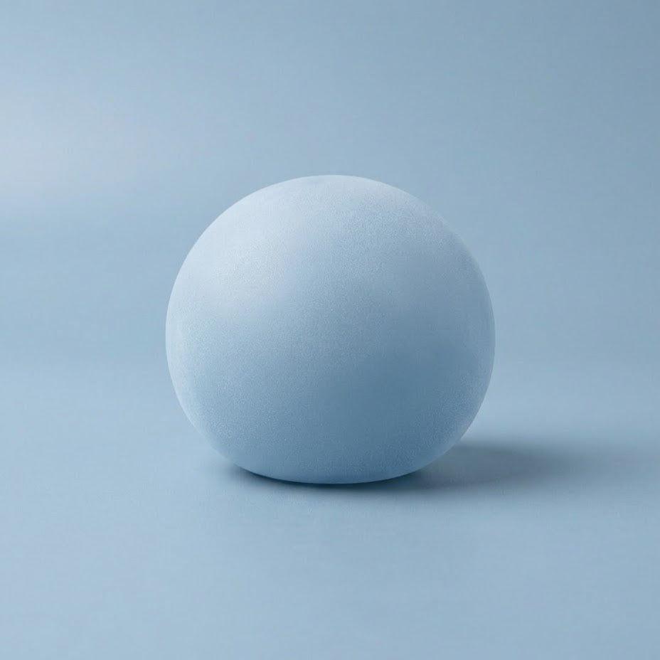 A matte light blue sphere centered on a matching light blue studio background with a soft shadow.