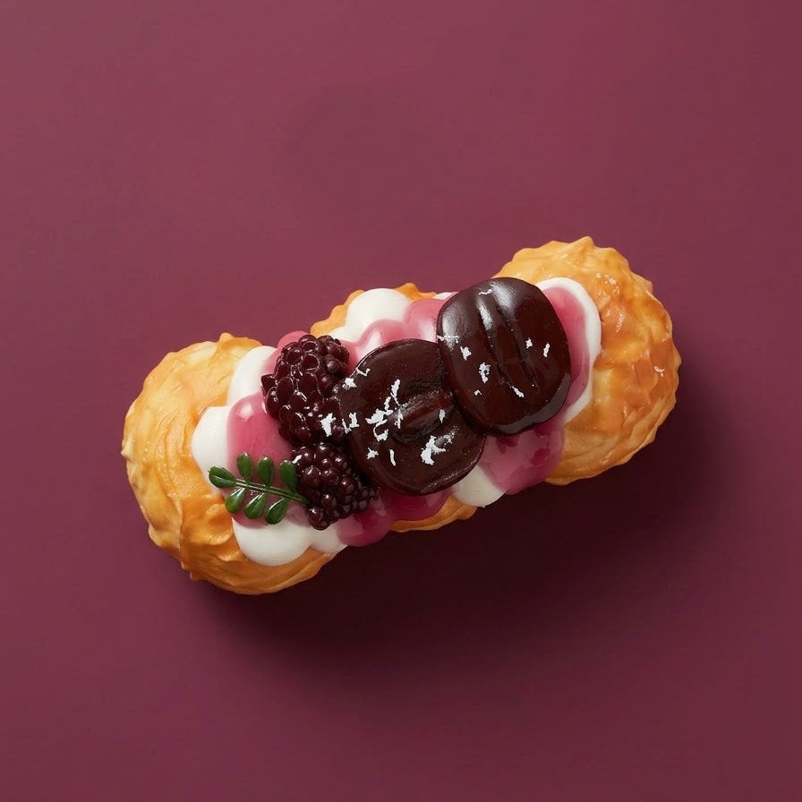 A single chocolate and berry cream panna pastry on a solid dark burgundy background.