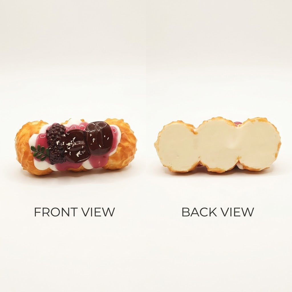 A close-up studio view of a pastry shown from two angles on a white background, labeled FRONT VIEW and BACK VIEW. The front view shows a cream-filled pastry with berry toppings, and the back view shows the cream filling exposed on a split cross-section.