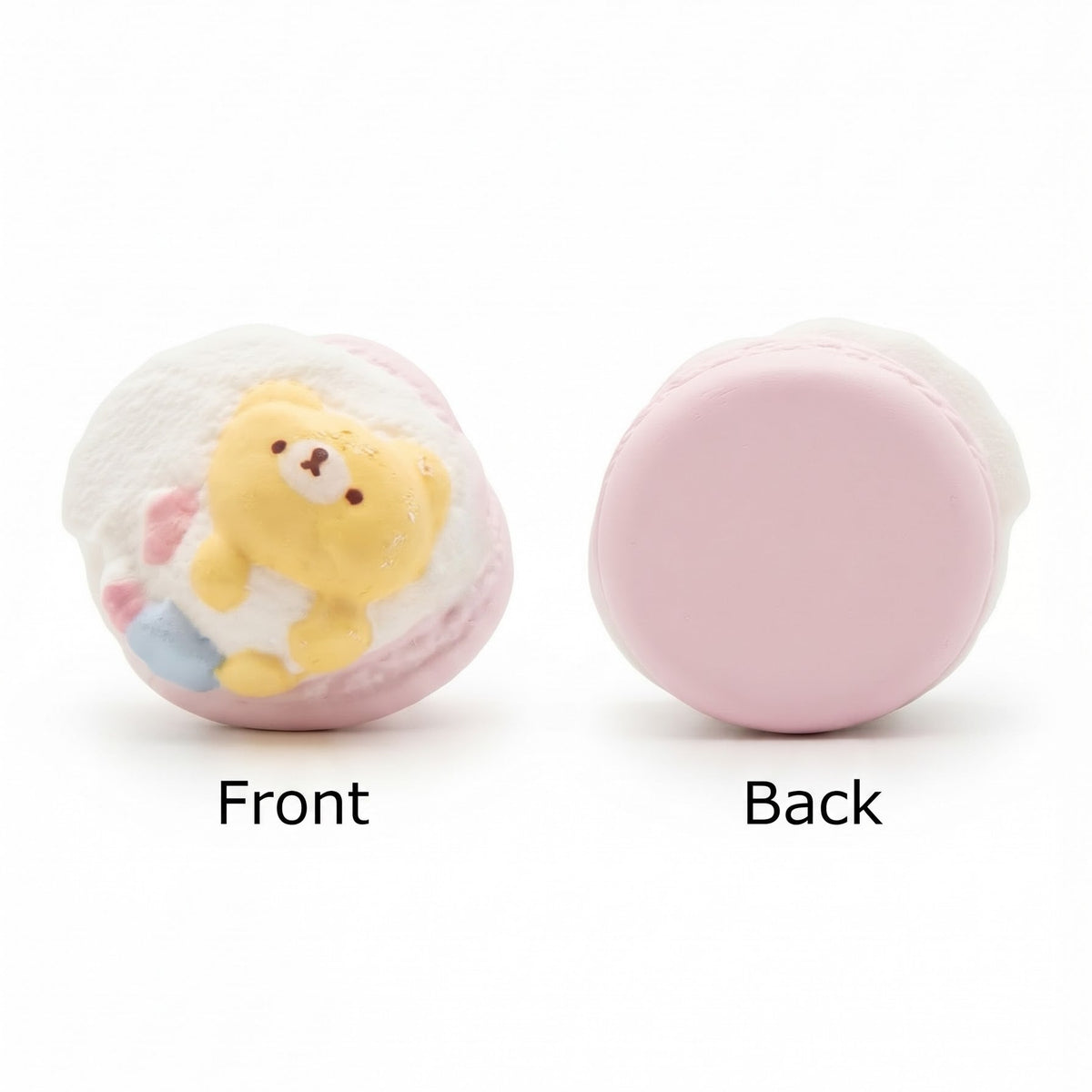 A pink macaron-shaped squishy toy shown from both front and back views on a white background. The front view shows a pastel pink shell with a yellow bear character sitting inside, while the back view shows the smooth pink inner surface.