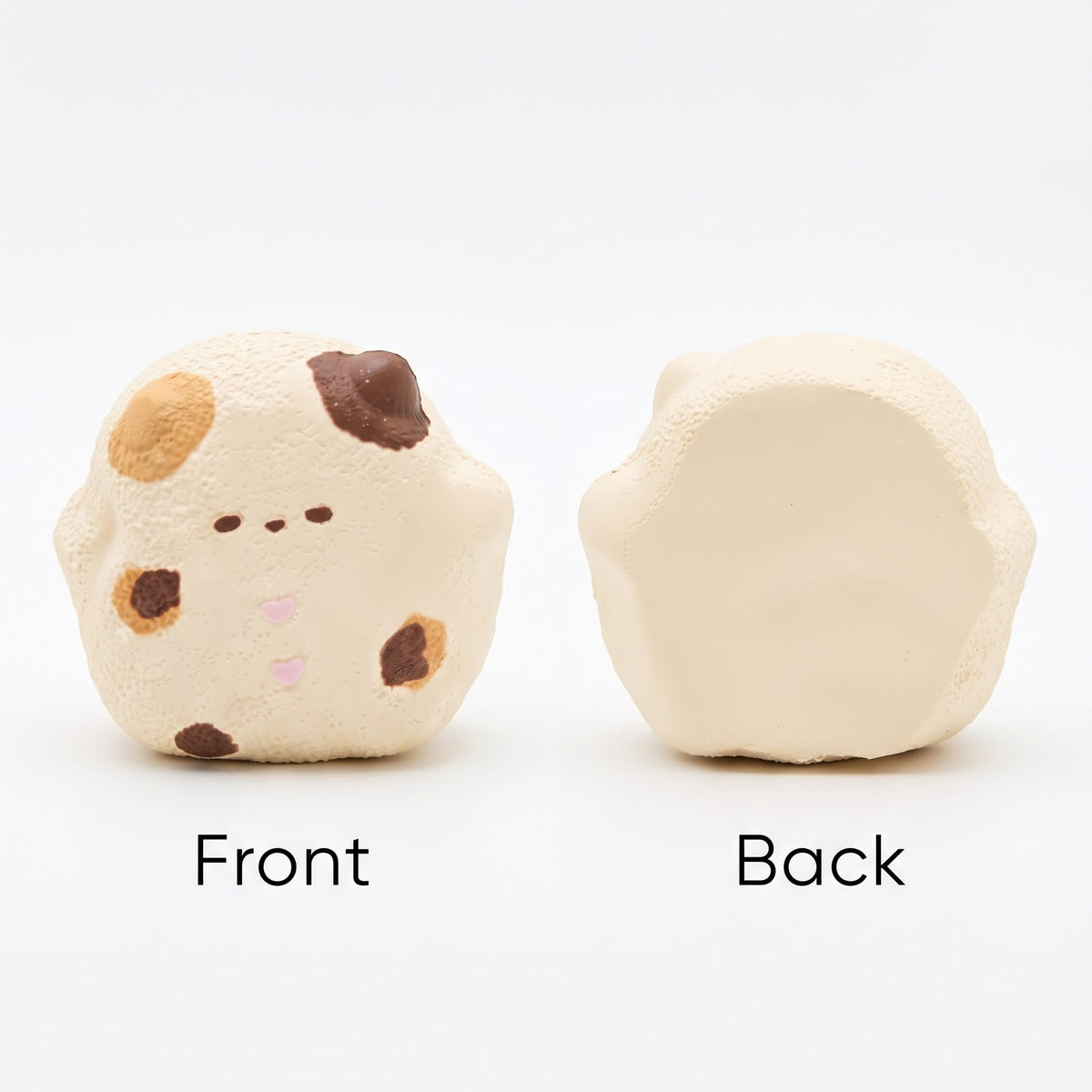 A small rounded cream-colored plush or foam toy shown from both sides on a white background, labeled 'Front' and 'Back'. The front has a cute minimalist face and a few brown and tan spots, while the back is plain.