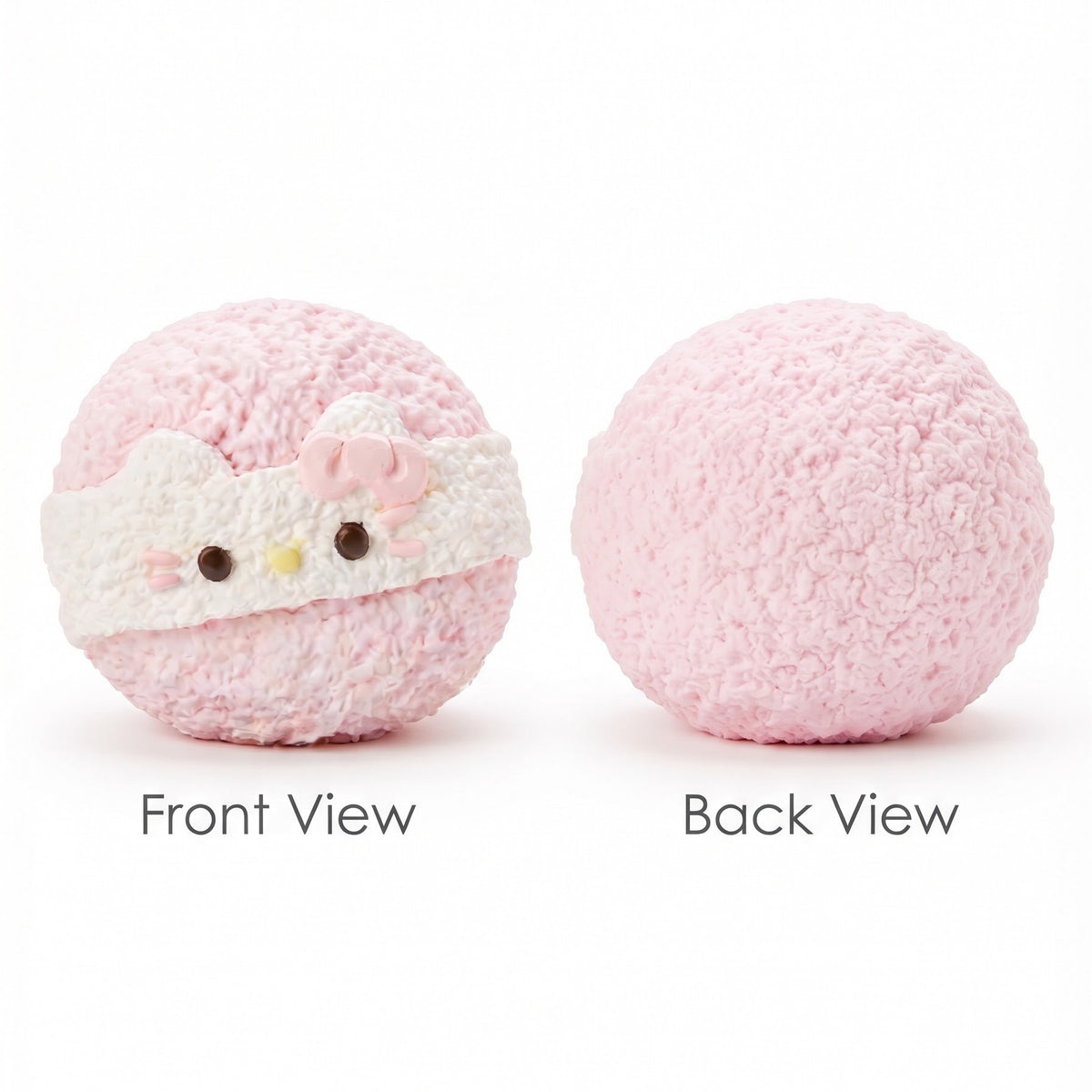A pink fuzzy round plush toy shown from two angles on a white background, labeled 'Front View' and 'Back View'. The front view shows a white eye mask with Hello Kitty-style facial details, including small pink bow, black eyes, and a yellow nose.