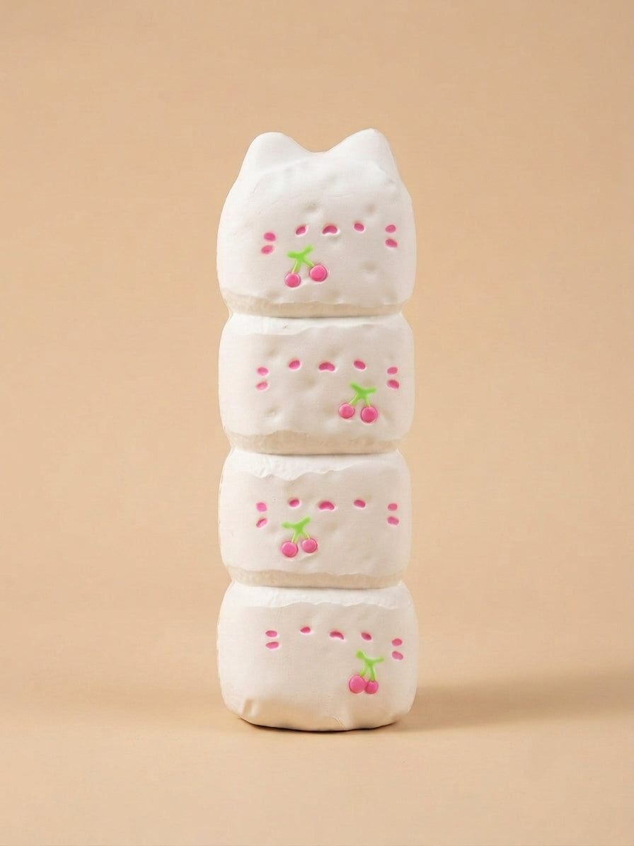 A stack of four white ceramic cat-shaped coasters with pink cherry designs, set against a solid beige background.