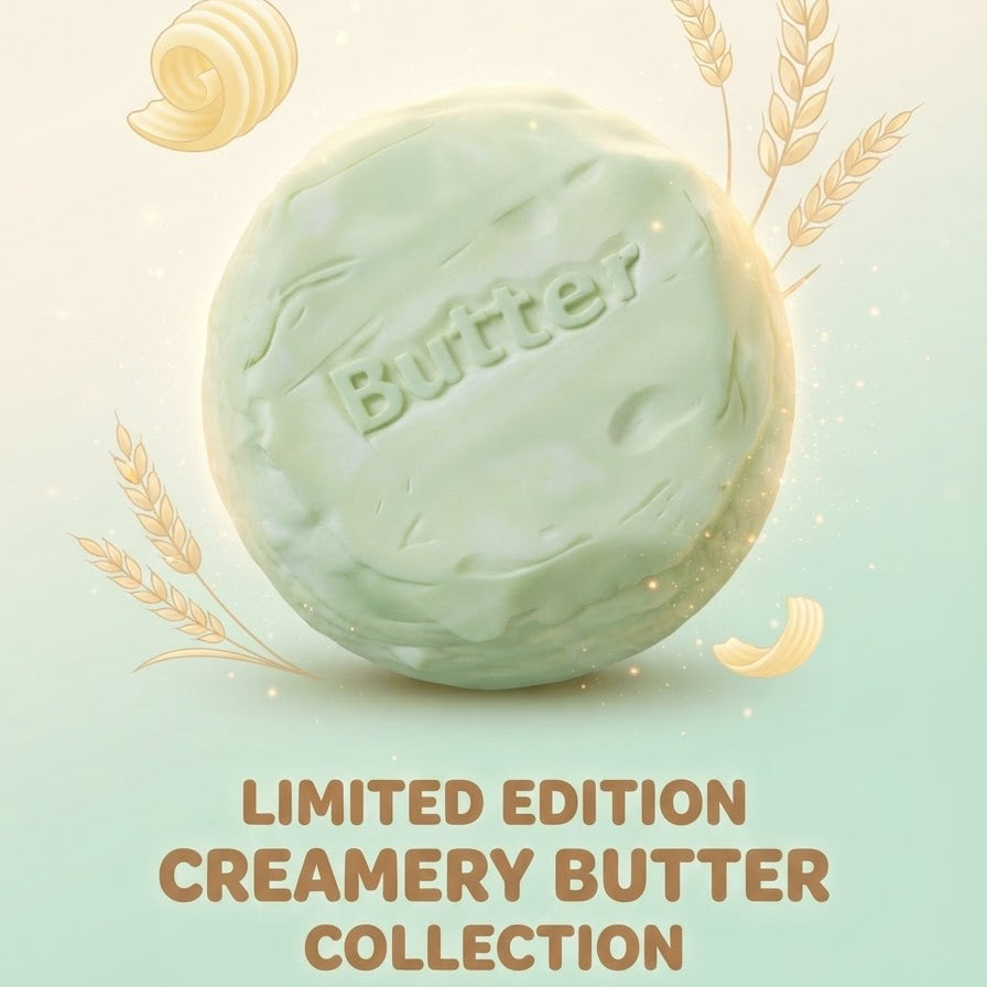 A single round creamery butter bar with the word 'Butter' embossed on the front, shown on a soft pale green background with decorative wheat illustrations and the text 'LIMITED EDITION CREAMERY BUTTER COLLECTION' below.
