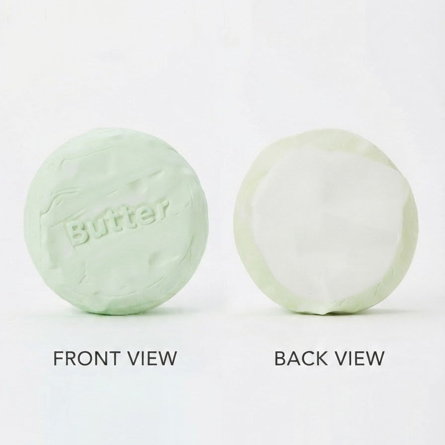 A pale mint green round bar of soap shown from both front and back on a white background, with the word 'Butter' embossed on the front and 'FRONT VIEW' and 'BACK VIEW' text labels below.