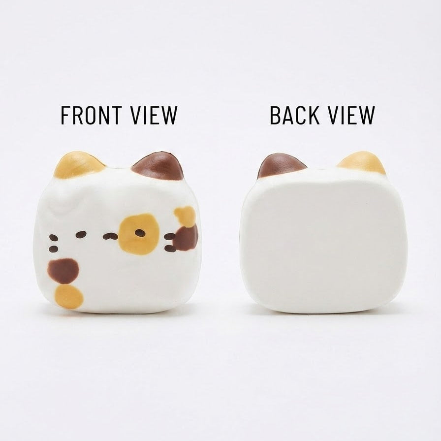 A white cat-shaped squishy toy shown from the front and back on a plain white background, with text labels reading 'FRONT VIEW' and 'BACK VIEW'. The front view shows small brown and yellow ear accents, a simple black face, and yellow and brown spots.