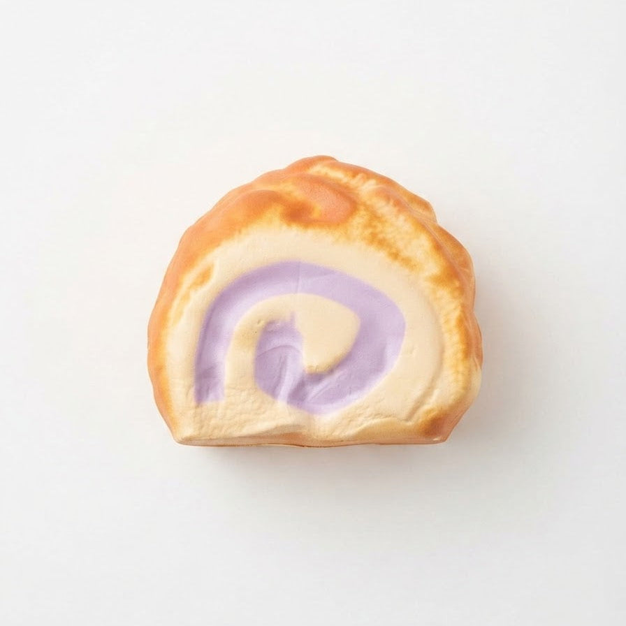 A single slice of a baked pastry or roll with a golden-brown crust and a lavender-purple cream swirl inside, centered on a plain white background.
