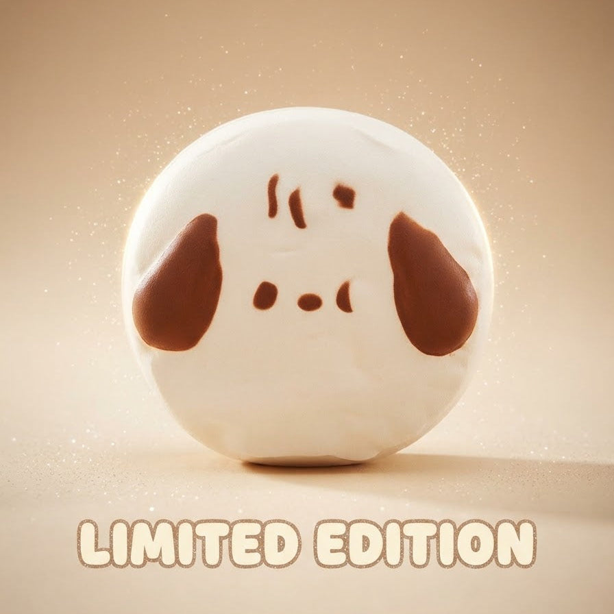 A round white ceramic figurine with a simple brown face and ears, shown on a warm beige background with the text 'LIMITED EDITION' at the bottom.