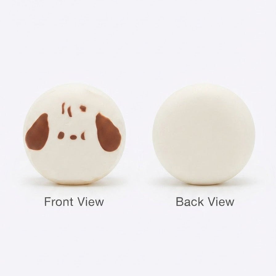 Two round cream-colored items shown on a white background, labeled Front View and Back View. The left item has a simple brown face design, and the right item is plain.