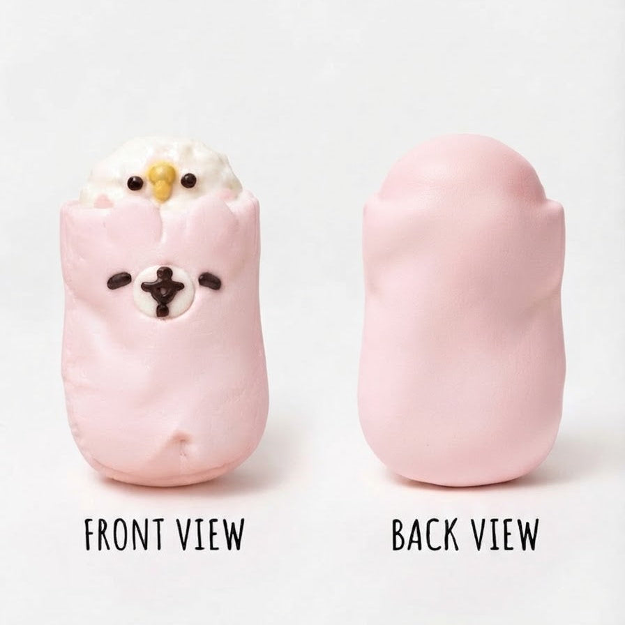 A pink squishy toy shown in front and back views on a light gray background. The front view shows a cute bird face with white feathers and small black eyes and beak.
