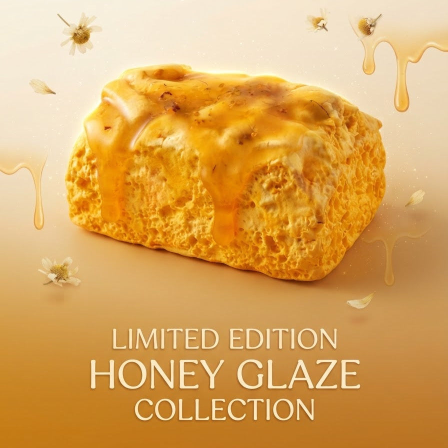 A golden-brown honey-glazed pastry or scone-like baked good centered on a warm beige-to-amber gradient background, with decorative honey drips and small white flower accents. Text at the top and bottom reads 'LIMITED EDITION HONEY GLAZE COLLECTION'.