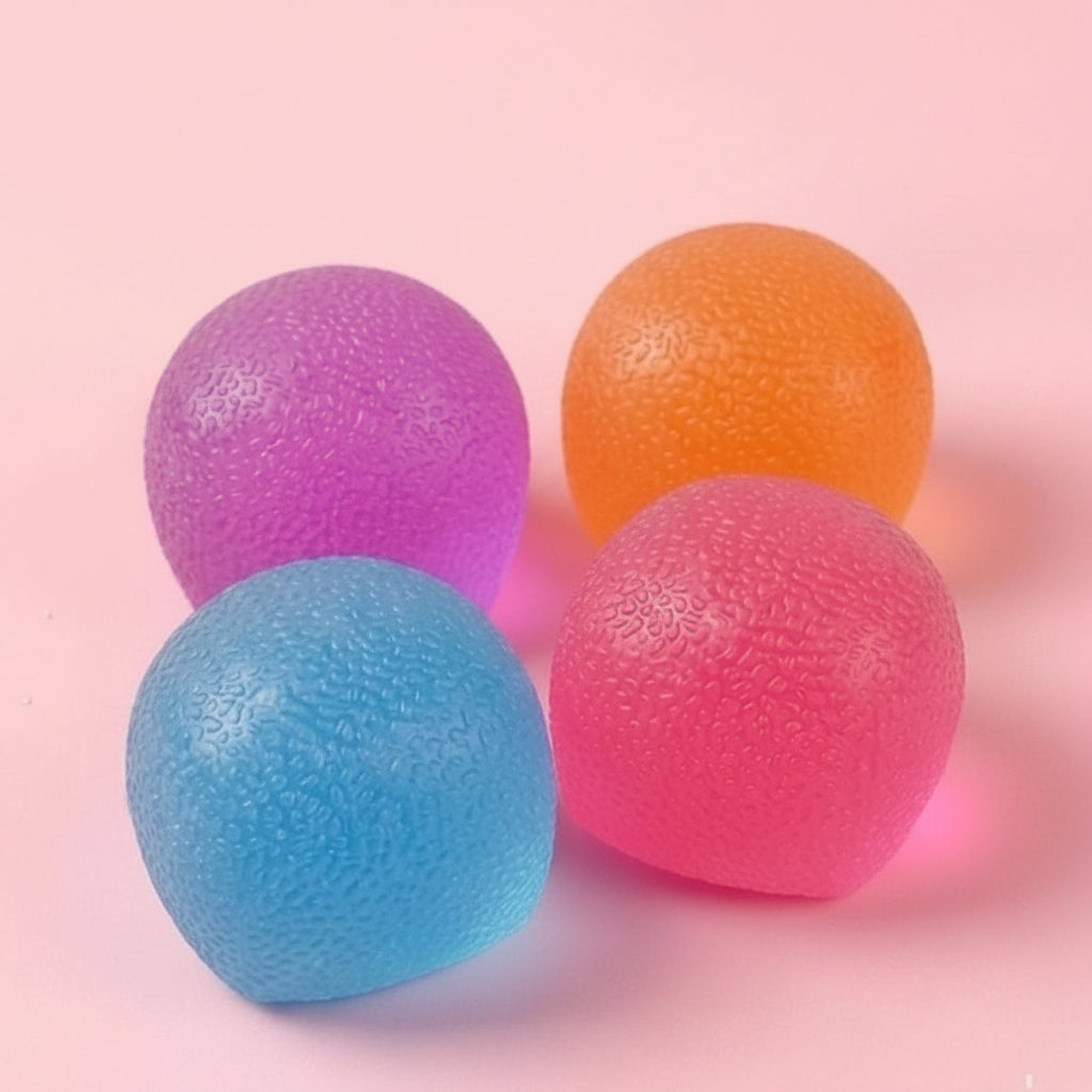 Four colorful stress balls with a 'Stres Free Squeeze' sign in the background on a pink background.