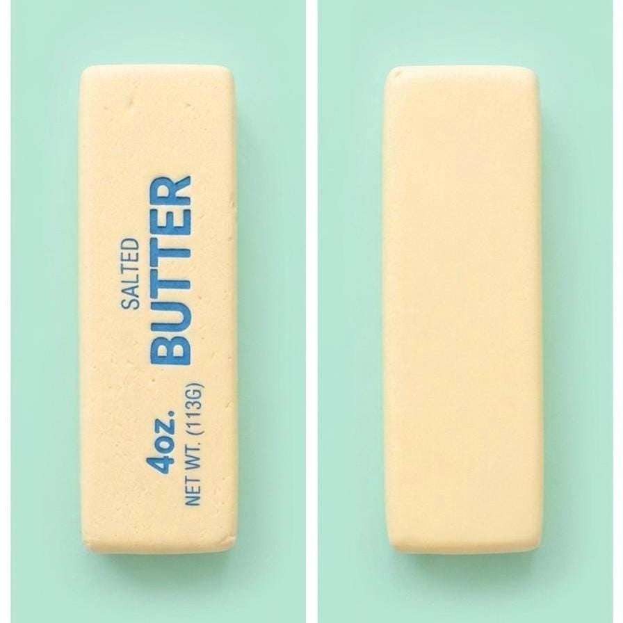 Two pale yellow sticks of butter shown on a mint green background, one with blue text reading 'SALTED BUTTER 4 oz. NET WT (113G)'.