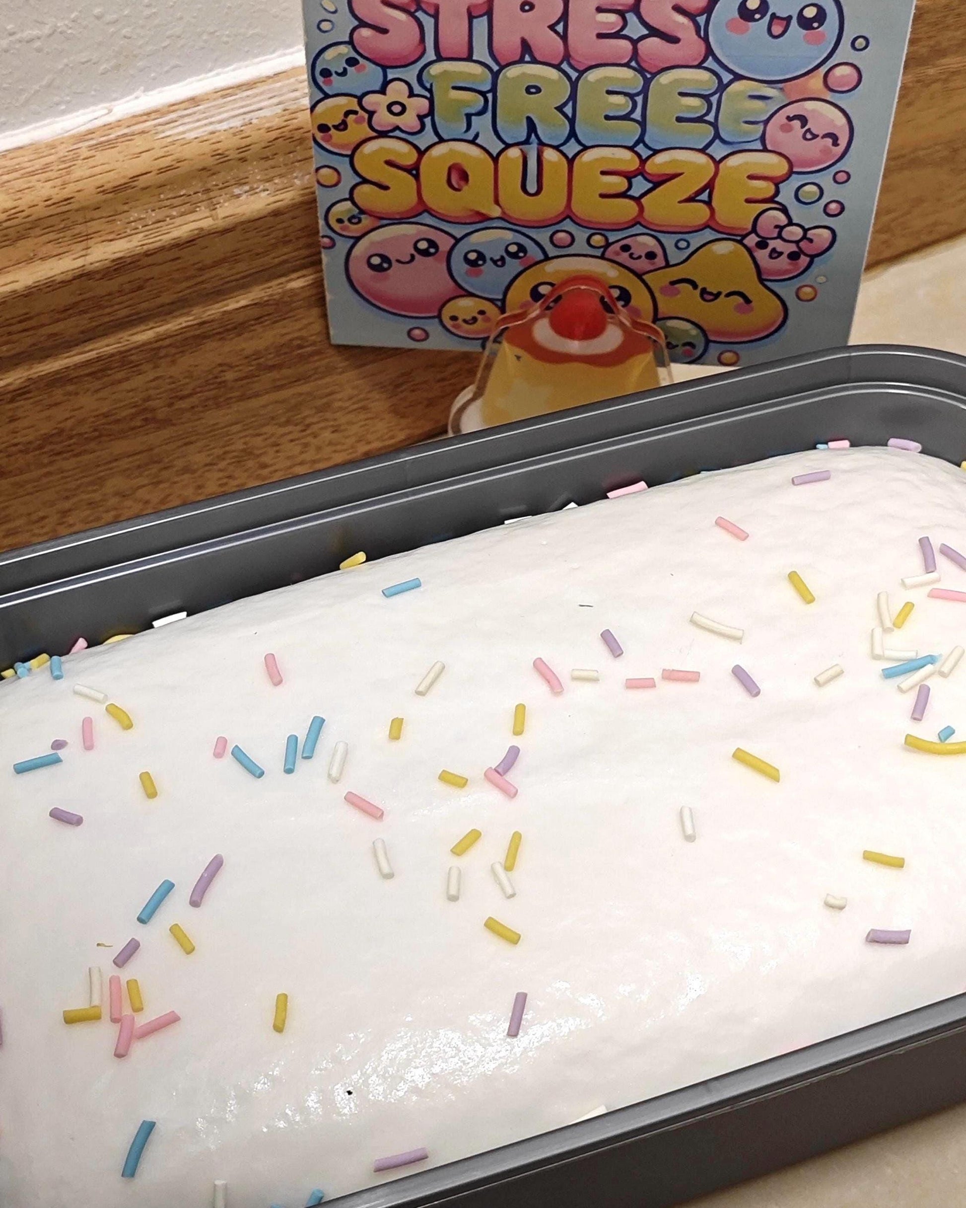 Stress ball with colorful sprinkles on a tray, with a 'Stress Free Squeeze' box in the background.