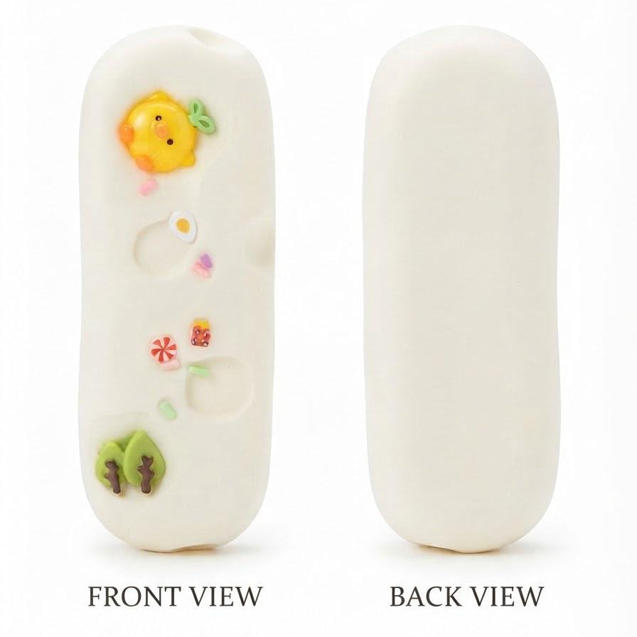 An off-white, egg-shaped accessory shown from both the front and back. The front view features small colorful molded details including a yellow chick, a green leaf, and tiny flowers.