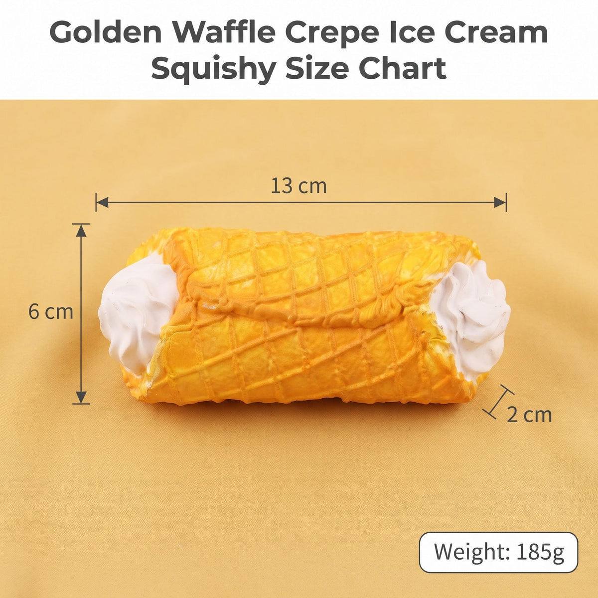 Golden waffle crepe ice cream squishy size chart showing a cylindrical ice cream cone roll with whipped cream ends on a beige background, with dimension labels of 13 cm, 6 cm, and 2 cm, plus a weight label of 185g.